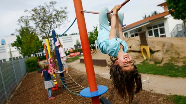 Children play in the garden of their kindergarten run by a private foundation in Hanau