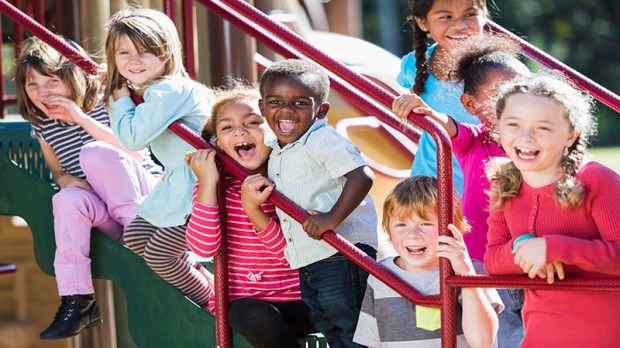 Big group of multi-ethnic children on a sunny playground